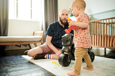 Buy stock photo Dad, baby and living room walking for mobility development, learning and growth in a home. House, family and young kid with father playing with toy car with love, parent support and care for toddler