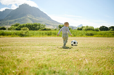 Buy stock photo Summer, sports and baby with soccer ball in field for playing, having fun and adventure in nature. Childhood, fitness and boy outdoors to play games, learning football skill and happiness on grass