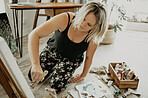 Woman, painting and creative art in studio, home or house with brush, paint and canvas. Artist person and relax painter with talent for design in workshop