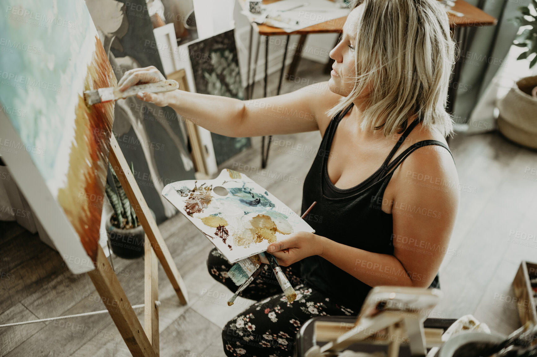 Buy stock photo Woman, painter and painting with palette, canvas and creative person with talent in studio. Creativity, art and female artist with brush, watercolor and easel for craft, concentration and inspiration