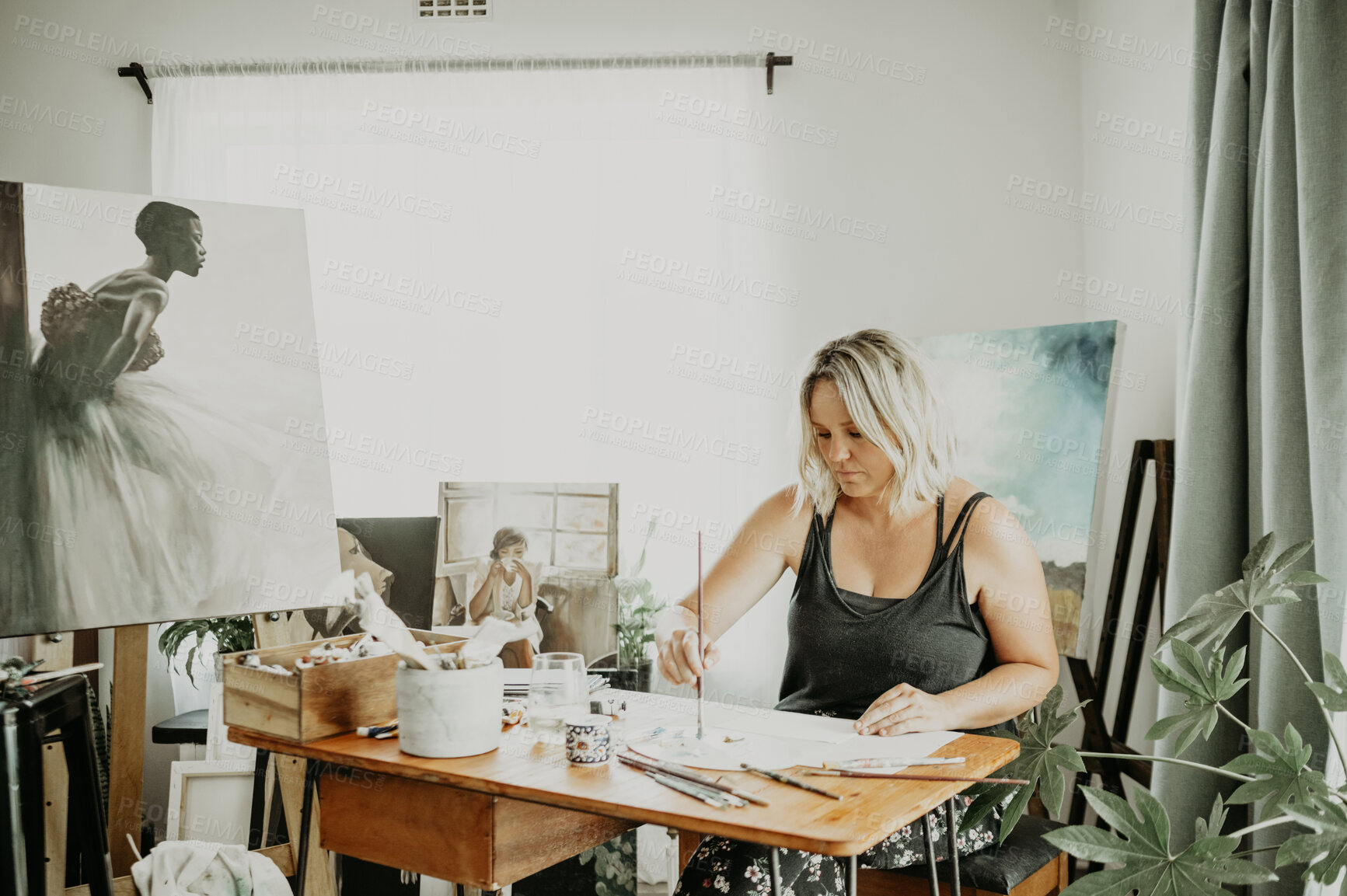 Buy stock photo Art, studio and woman painting in her home on a canvas with creative vision, focus and inspiration. Creativity, painter and young female artist creating an artwork design with a brush at her desk.