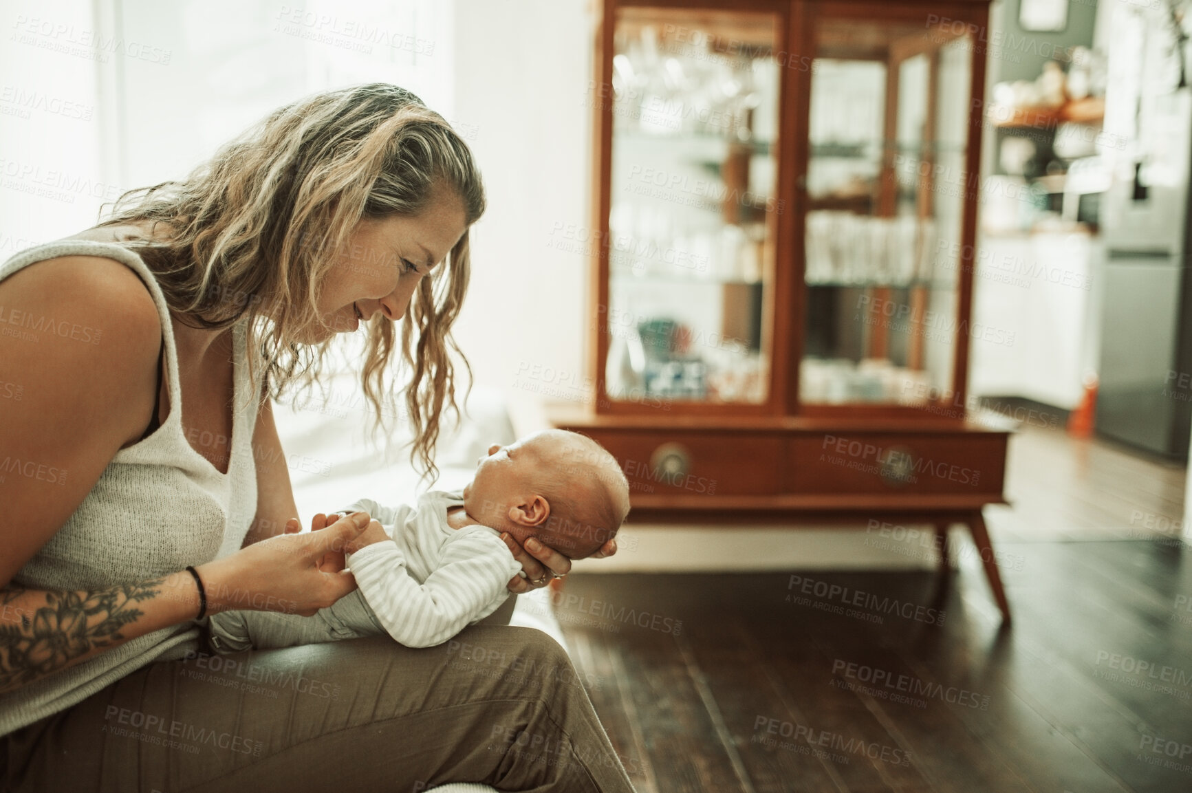 Buy stock photo Mother, holding baby and smile in home for love, care and bonding together. Happy mama, newborn and cute kid, infant or toddler in comfort, relax and playing while enjoying quality time in house.