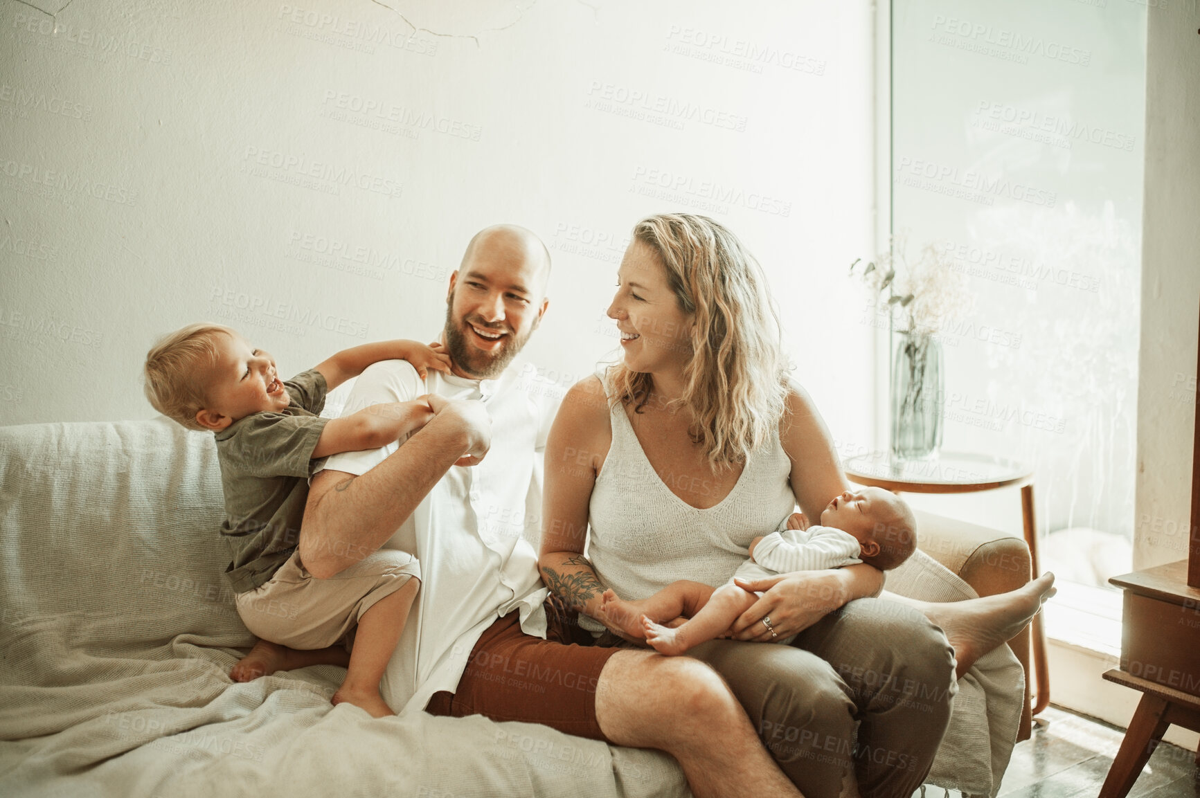 Buy stock photo Parents, children and a family laughing on the sofa in the living room of their home together for bonding. Mother, father and kids in the house with a baby and cute boy child joking in the lounge