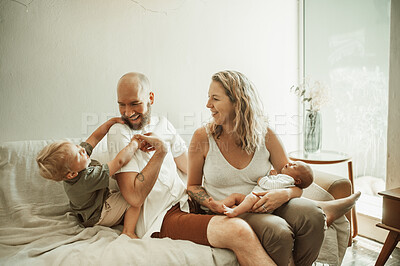 Buy stock photo Parents, children and joy with a family on the sofa in the living room of their home together for bonding. Mother, father and kids in the house with a cute baby and playful boy laughing in the lounge
