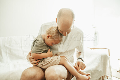 Buy stock photo Dad, kid and sitting on lap in home for love, care and bonding together on sofa. Father, boy and child playing, enjoying quality time in house living room with parent on couch in lounge and relax.