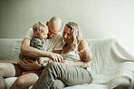 Family, baby and parents on a couch, newborn and happiness with joy, bonding and loving together. Mother, father and children on a sofa, love and care with quality time, having fun and relax at home 