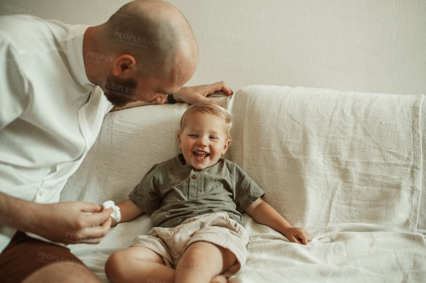 Buy stock photo Father, child and wipe nose of sick kid on sofa in home living room, funny and laugh for care. Dad, boy and toddler with tissue for flu, allergies or cold, virus or disease, illness or covid in house