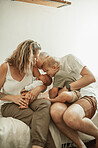 Mom, dad and family kiss baby on couch, sofa or quality time together in living room, home or house. Mother, father and parents to love, support or care for young children, kids and embracing babies 