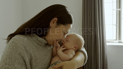 Buy stock photo Kiss, love and mother bonding with her newborn in the modern nursing room at family home. Smile, care and young mom holding her infant, baby or child with happiness in the bedroom of house in Canada.
