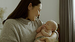 Care, family and mom bonding with her newborn for nap time in a modern nursery room at home. Smile, love and happy young mother holding her sleeping infant, baby or child with happiness in bedroom.
