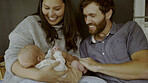 Mother, father and baby on a sofa to relax in the living room of their home together for love, care or bonding. Family, smile or happy with parents holding their cute newborn infant chid in a house