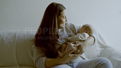 Buy stock photo Happy, smile and mother with her baby on a sofa for relaxing, bonding and resting in living room. Love, care and young mom holding her infant, newborn or child with happiness in lounge of family home
