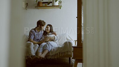 Buy stock photo Mother, father and baby on a sofa in their home living room together for love, care or bonding. Security, smile and relax with happy young parents holding their cute newborn infant chid in a house