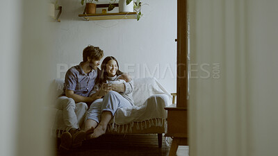 Buy stock photo Family, parents and baby on a sofa in the living room of their home together for love, care or bonding. Mother, father and relax with happy people holding their cute newborn infant chid in a house