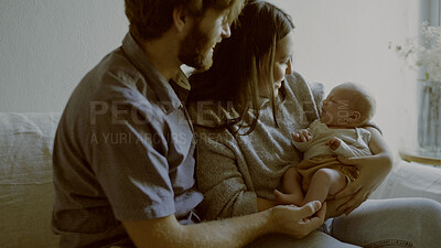 Buy stock photo Mother, father and baby on a sofa in the living room of their home together for love, care or bonding. Family, smile and relax with happy parents holding their cute newborn infant chid in a house