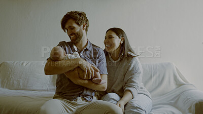 Buy stock photo Smile, parents and baby on a sofa in the living room of their home together for love, care or bonding. Family, relax or happy mother and father holding their cute newborn infant chid in a house