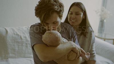 Buy stock photo Kiss, mom or dad with a newborn in a happy family to relax or bond together for child development. Smile, parents or proud father with mother or baby infant for love, safety or trust on sofa in home