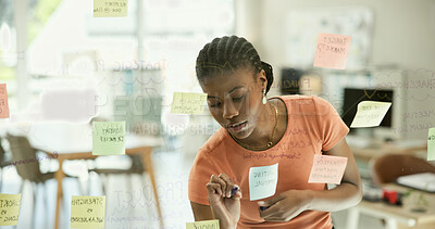 Buy stock photo Black woman, writing and schedule planning on glass board for strategy, ideas or reminder at office. African female person or creative employee for startup project plan, tasks or agenda at workplace