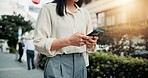 Phone, hands and woman in city for networking, communication or typing email on vacation. Cellphone, contact and female person reading online blog for holiday tips or advice in town in Japan.