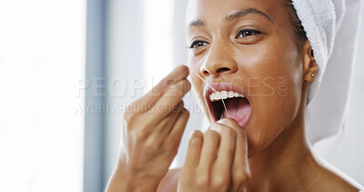 Buy stock photo Woman, dental and flossing teeth in home, orthodontics routine and cosmetics in bathroom. Female person, oral health and string to remove plaque or enamel, clean and self care or thread for hygiene