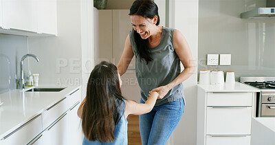 Buy stock photo Mama, daughter and holding hands for dancing in home, love and support with learning movement. Mother, girl and teaching steps to child in kitchen, family fun and listening together to sound of music