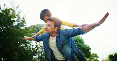 Buy stock photo Dad, piggyback and outdoor flying with son, fantasy adventure and holiday park for bonding. Happy family, father and nature for support with airplane games, garden freedom and together on vacation