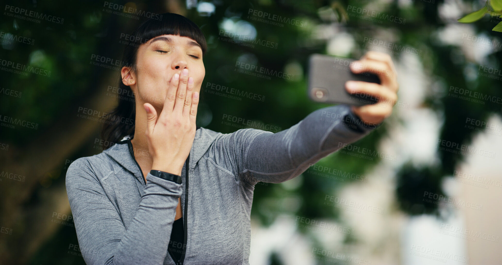 Buy stock photo Kiss, fitness and selfie and woman in park for social media, profile picture and online post. Outdoors, nature and person with emoji take photo after workout, exercise and training for wellness