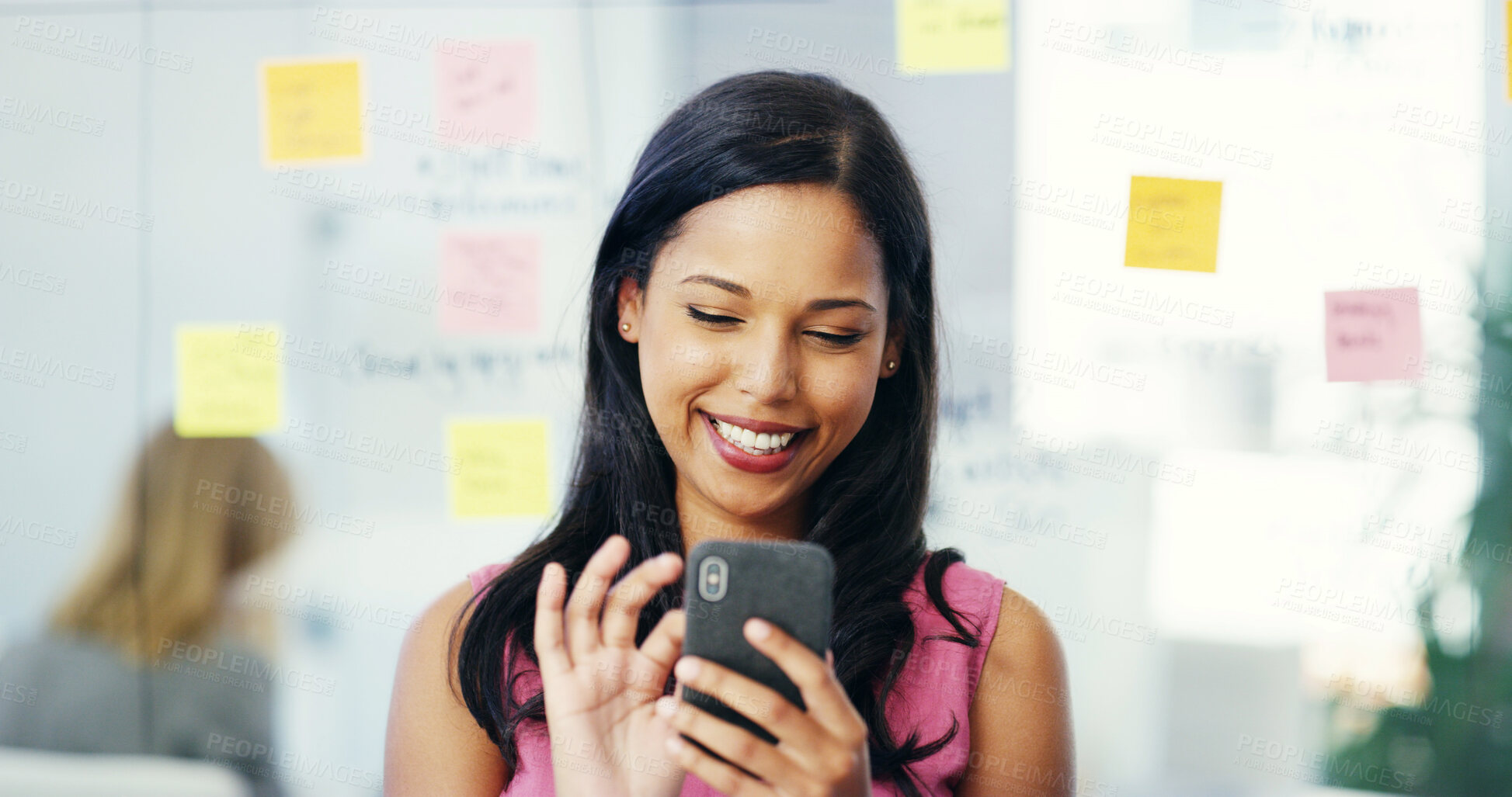 Buy stock photo Phone, smile and storyboard with business woman in creative office for news or networking. App, contact and social media with happy design employee in workplace for communication or text message