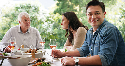 Buy stock photo Dinner, portrait and smile of man with family outdoor in garden of home for eating food or meal. Drink, feast and visit with group of happy people at apartment for bonding or social gathering