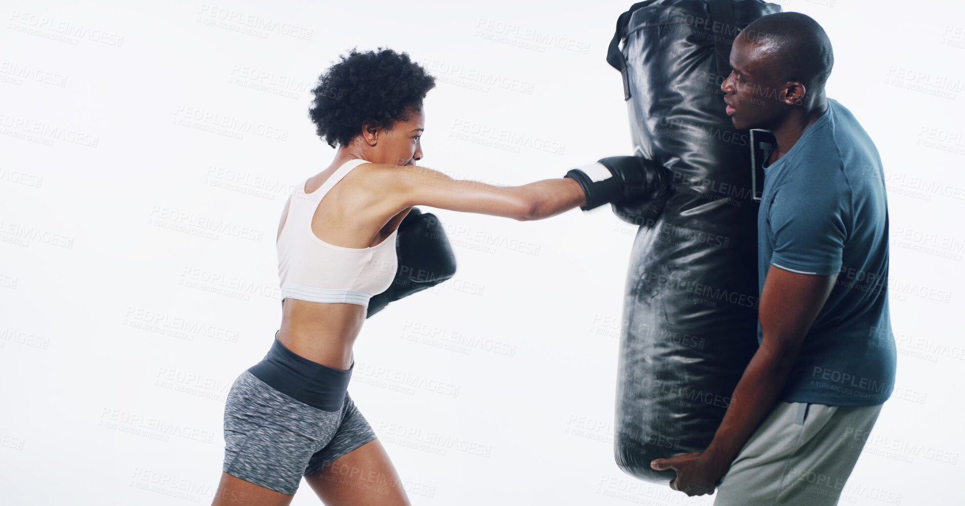 Buy stock photo Woman, man and boxer with coach for punching bag, fitness or training for progress by white background. African people, exercise or mentor with martial arts equipment, power or combat sport in studio