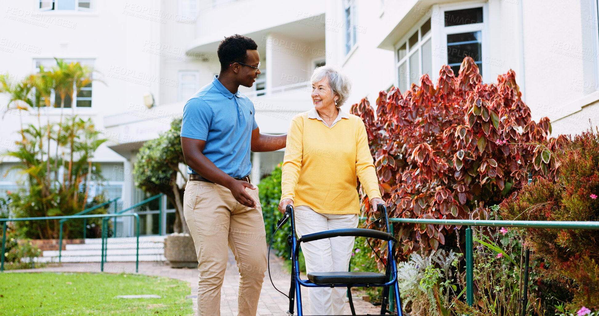 Buy stock photo Caregiver, outdoor and support with old woman and walker for rehabilitation, healthcare or helping. Medical, advice and nurse with person with a disability in nursing home for elderly care and trust
