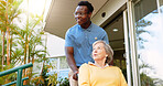Senior woman, nurse and wheelchair with physiotherapist for walk, support or assisted living in garden. Happy, caregiver or medical worker with elderly patient or person with a disability at hospital