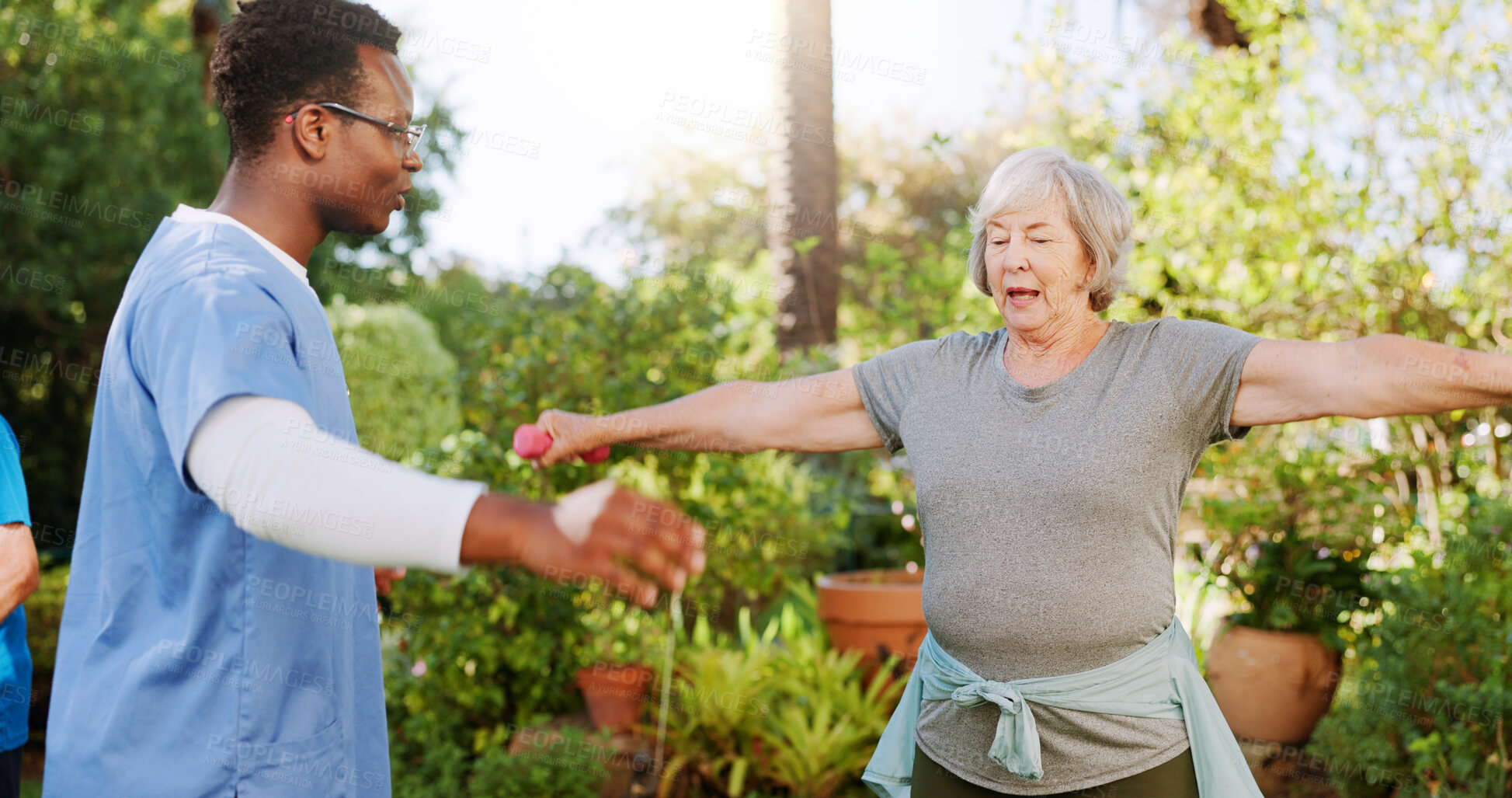 Buy stock photo Stretching, weights and coaching with old woman and nurse outdoor for help healthcare and support. Medical, rehabilitation and retirement with senior patient in nursing home for fitness class