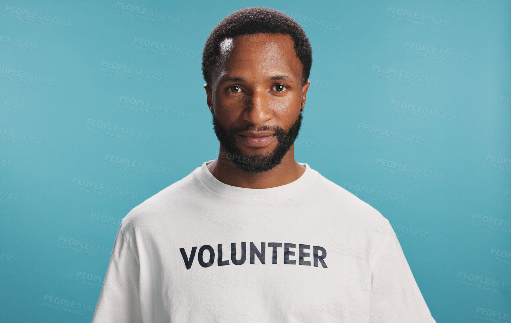 Buy stock photo Volunteer, serious and portrait of man in studio with ngo community project for donation. Confident, face and African male charity worker with social responsibility activism by blue background.