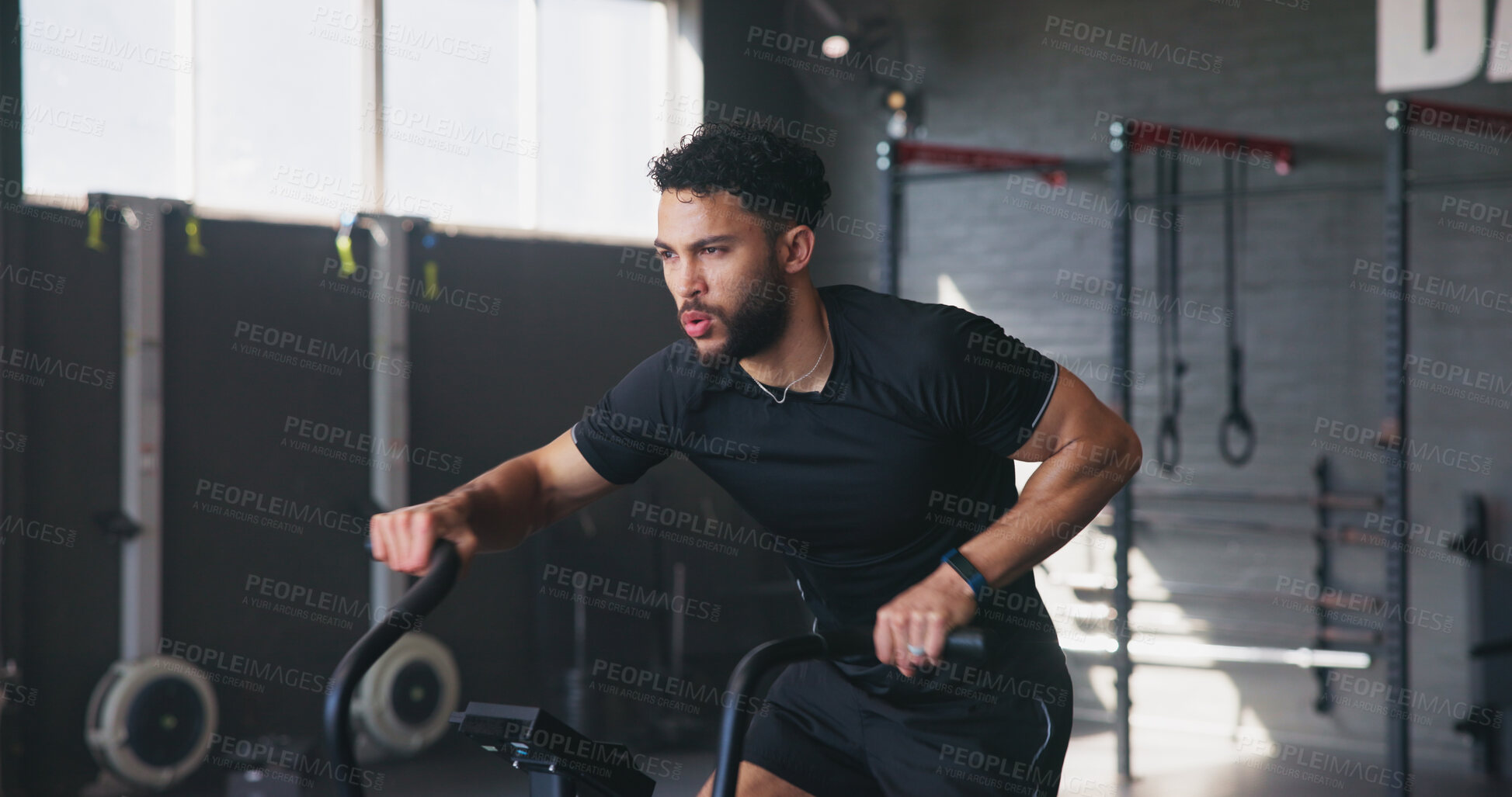 Buy stock photo Fitness, man and bicycle machine in gym for exercise, cardio workout and training. Athlete, stationary bike and breathing in wellness center for triathlon preparation, intense cycling and aerobics