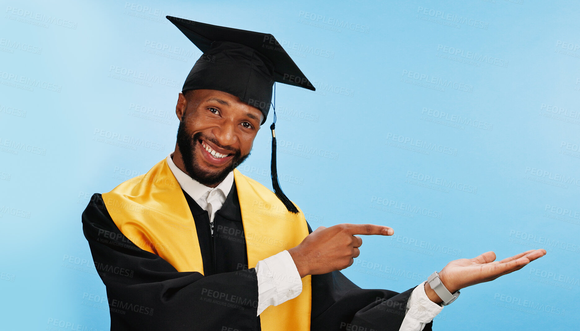 Buy stock photo Portrait, black man and pointing for graduation in studio for celebration, education success and sign up. Mockup space, student and hand gesture with ceremony feedback, university and blue background