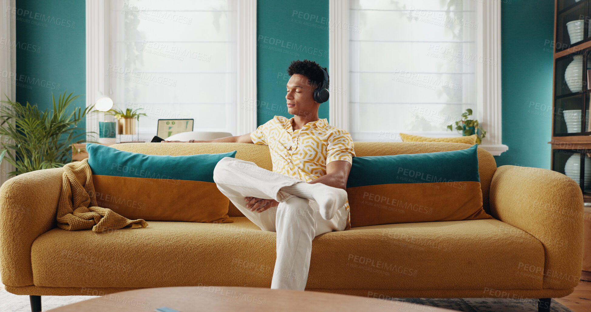 Buy stock photo House, thinking and man on sofa, headphones and relax with radio, wonder and calm in lounge. Person, apartment and guy with headset, thoughtful and listening to music, sound and song with podcast