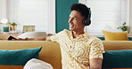 House, thinking and man on sofa, headphones and relax with smile, radio and calm in lounge. Person, apartment and guy on couch, headset and listening to music, sound and song with podcast and ideas