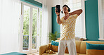 Man, winner and celebration dance with smartphone for good news, college acceptance in home. Achievement, victory and opportunity with student in living room for university scholarship and music