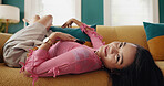 Calm, portrait and woman on couch, home and happy for break in living room, comfortable or relax. House, positive mindset and person on sofa in lounge, resting and cozy in apartment, smile or weekend