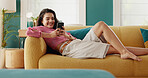 Phone, relax and happy girl on sofa, typing message and online post on social media profile. Mobile, home and woman on app for communication, check notification and playing games on internet to chill