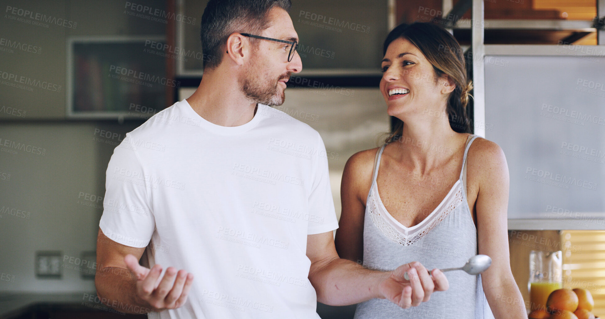 Buy stock photo Couple, smile and conversation in kitchen, morning or cooking breakfast with care in home. Mature man, woman and people with love, laughing and funny joke with partner, chat and happy at apartment