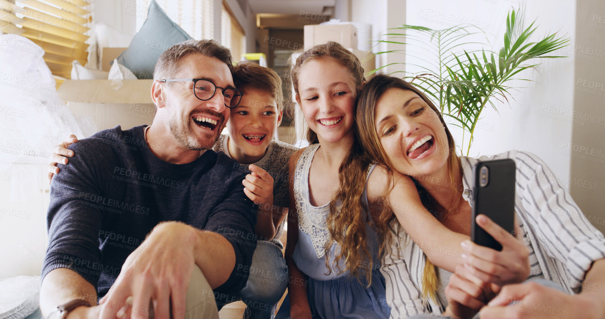 Buy stock photo Home, dad and mom with children for selfie, family memory and profile picture for social media. Parents, girl and boy with tongue out for photography, happiness and relationship with bonding in house
