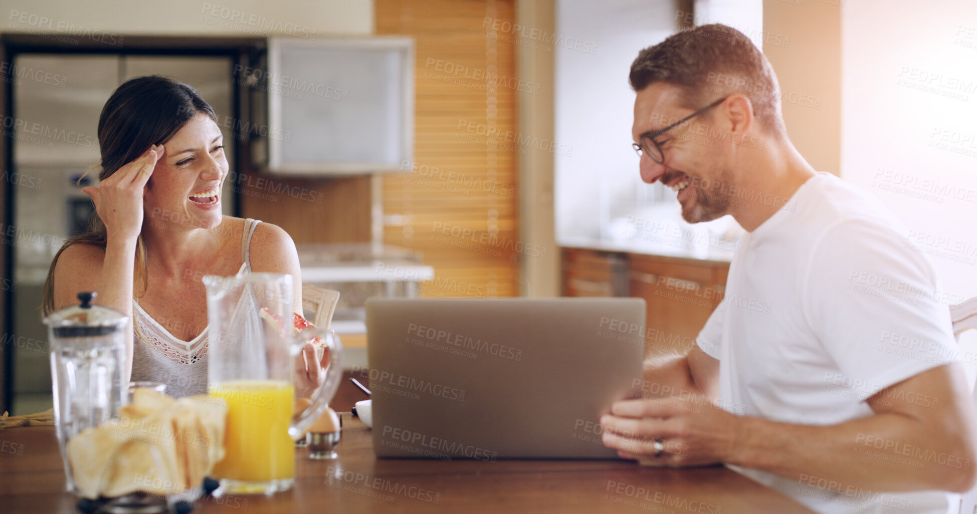 Buy stock photo Couple, happy and laptop in kitchen, breakfast and laugh with memory, streaming or social network in home. Mature man, woman and people with computer, food and funny video with subscription in house