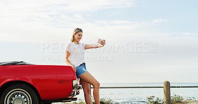 Buy stock photo Road trip, happy girl and selfie with car for travel, vacation or holiday outdoor by sea. Convertible transport, woman and picture on journey for memory, social media post and influencer vlogging