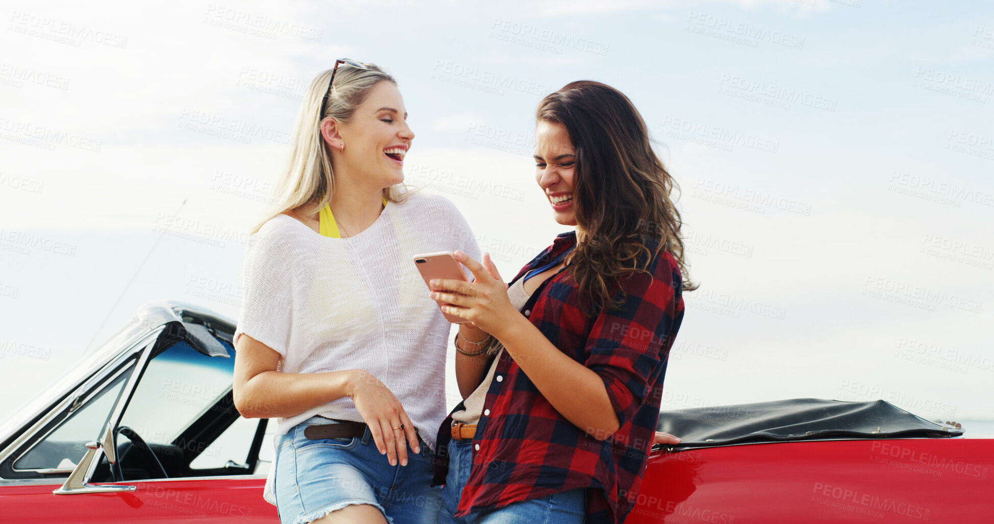 Buy stock photo Phone, women laughing and friends on road trip with car for vacation, holiday or excited for adventure. Mobile, convertible and girls on journey, travel and reading funny meme on internet outdoor