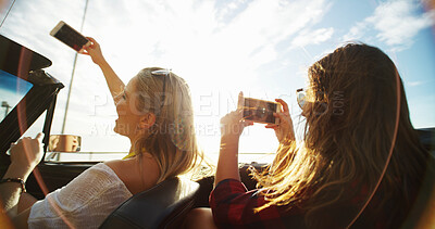 Buy stock photo Road trip, friends or women taking photo in car for travel, vacation or outdoor holiday together. Convertible transport, back or girls with picture for journey, weekend memory,  or social media post