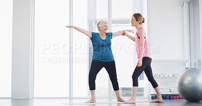 Buy stock photo Yoga, instructor and help woman with stretching for fitness, body health or warrior pose for senior wellness. Assistance, pilates coach or exercise together for balance, physiotherapy or smile in gym