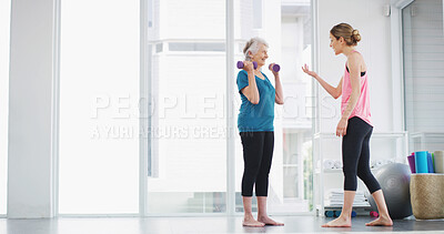 Buy stock photo Physiotherapy, senior woman and dumbbell for fitness, healthy body or workout for wellness. Weightlifting, happy coach and exercise together for muscle, strength training or help with recovery in gym