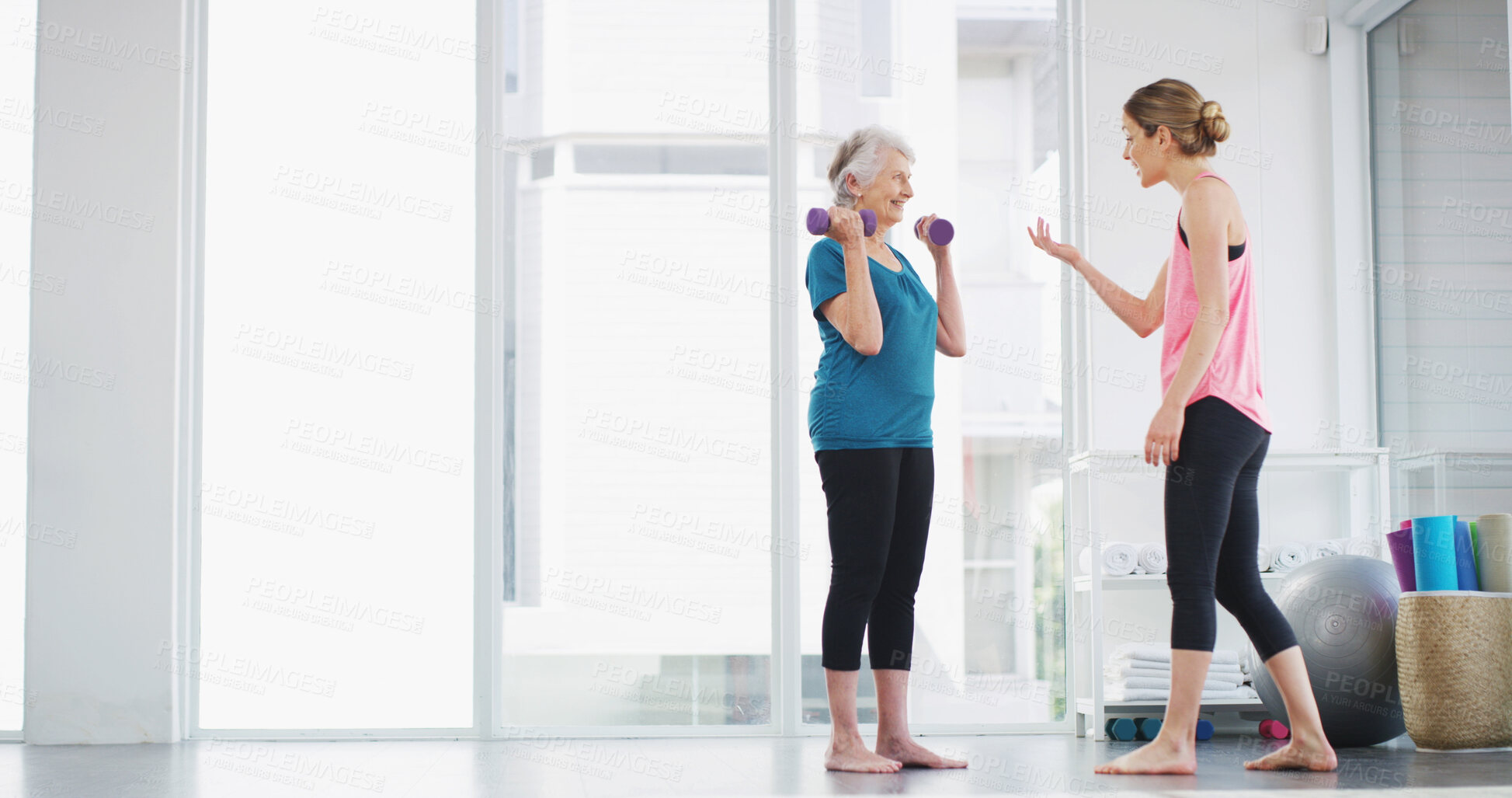 Buy stock photo Physiotherapy, senior woman and dumbbell for fitness, healthy body or workout for wellness. Weightlifting, happy coach and exercise together for muscle, strength training or help with recovery in gym